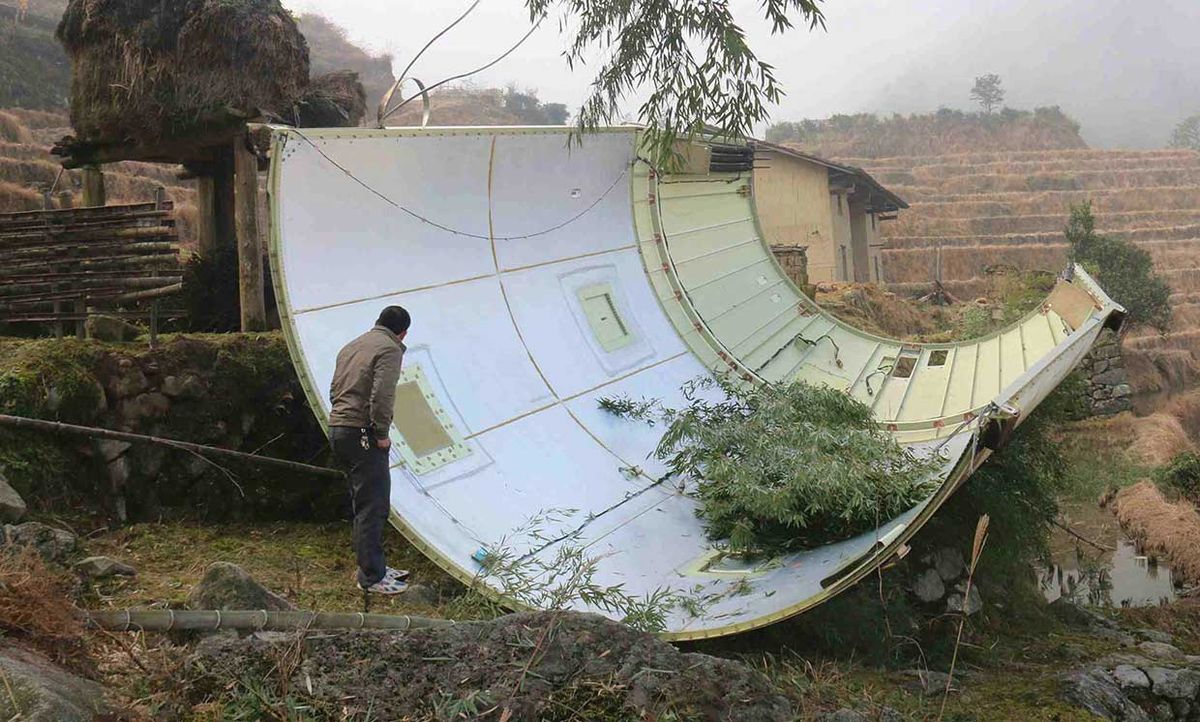 This picture taken on December 11, 2016 shows a piece of a Long March 3B rocket after it fell in a field in Suichuan County in China's central Jiangxi Province.