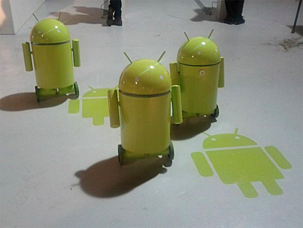 Three green two wheeled balancing robots that look like the Google Android logo