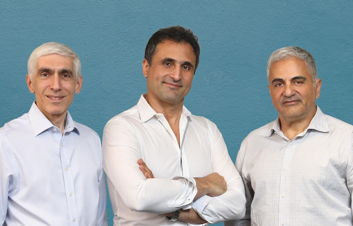 Three men of middle age in light color dress shirts.