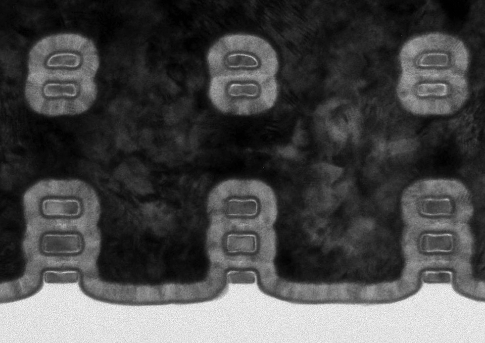 Three pairs of two grey rectangles float above three more pairs of grey rectangles in a black-and-white micrograph.