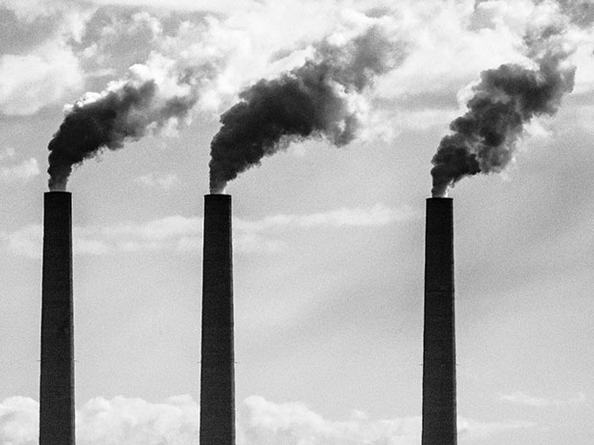 three power plant chimneys emitting vapor cloud
