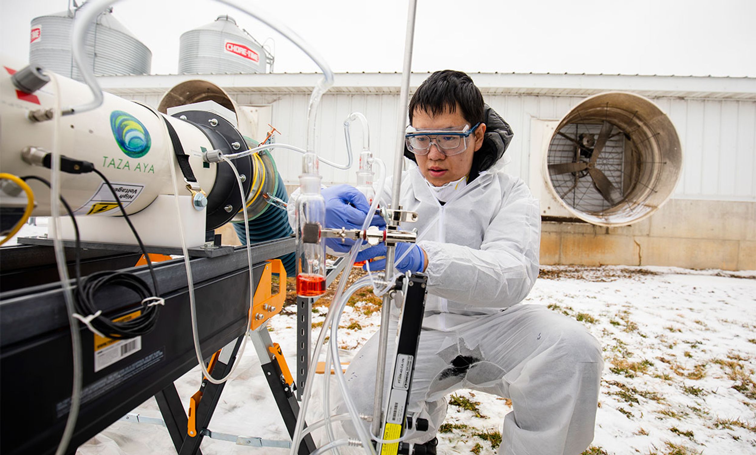 Tian Xia puts the final touches on a lab-scale non-thermal plasma device that can achieve 99% inactivation of an airborne viral surrogate, MS2 phage, a virus that infects E.coli bacteria at the Barton Farms family pig farm.