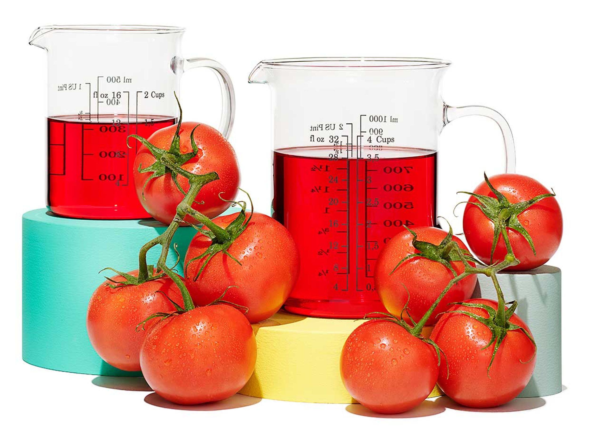 Tomatoes and beakers of red liquid.