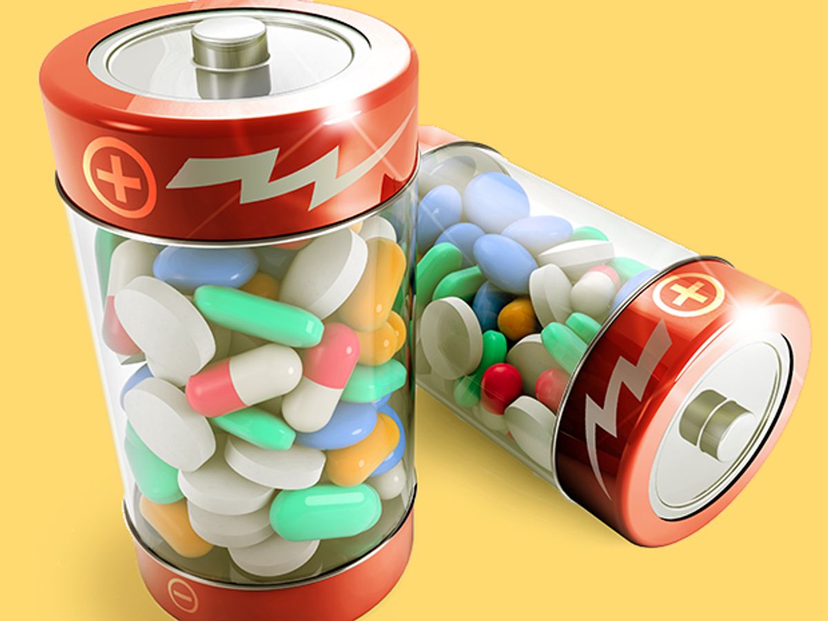 two batteries full of colorful pills on white background