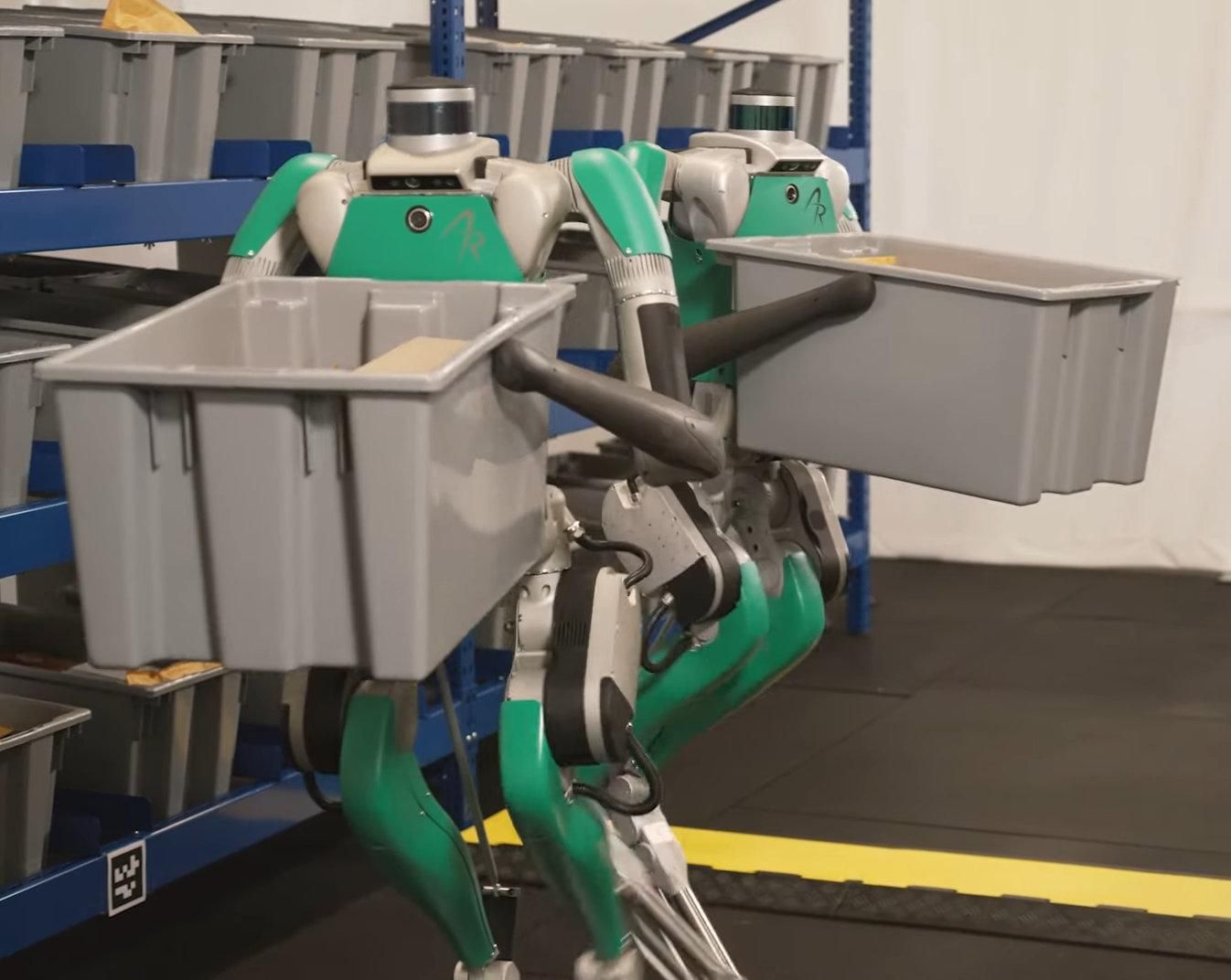Two digit robots working in a warehouse