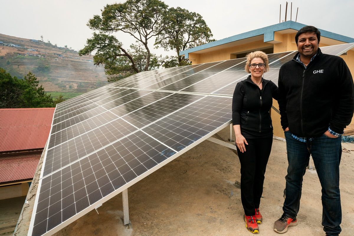 two-people-standing-in-front-of-solar-pa