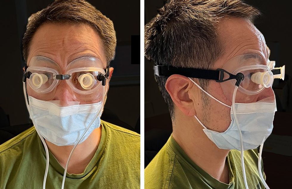 Two photos of a man show different views of him in a pair of clear goggles with cups over each eye and two tubes coming out of the sides.