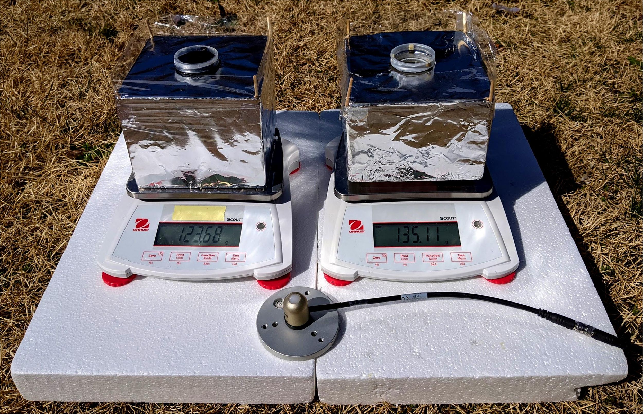 Two shiny square devices sit on equipment outside