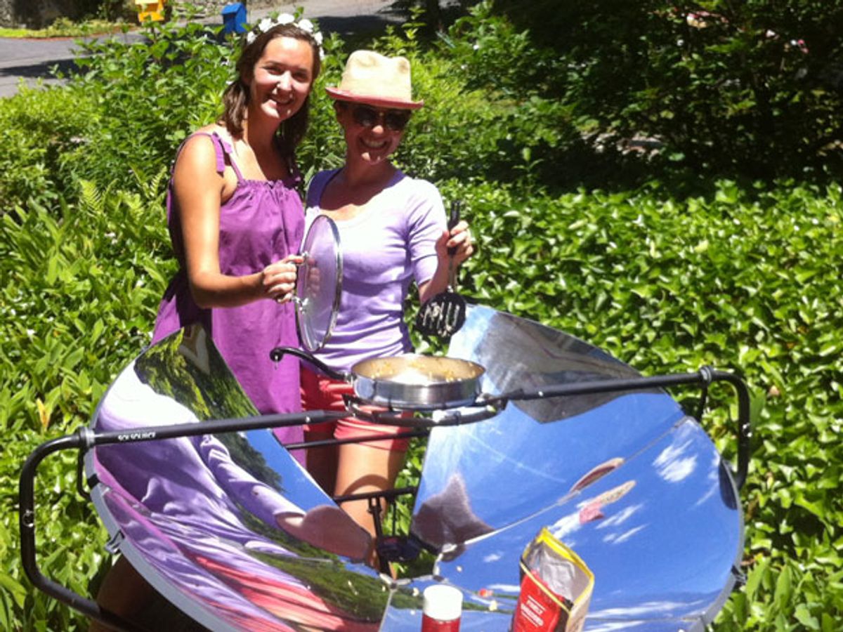 Two women and a solar cooker