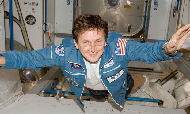 Photo of Charles Simonyi smiling while floating in the International Space Station.
