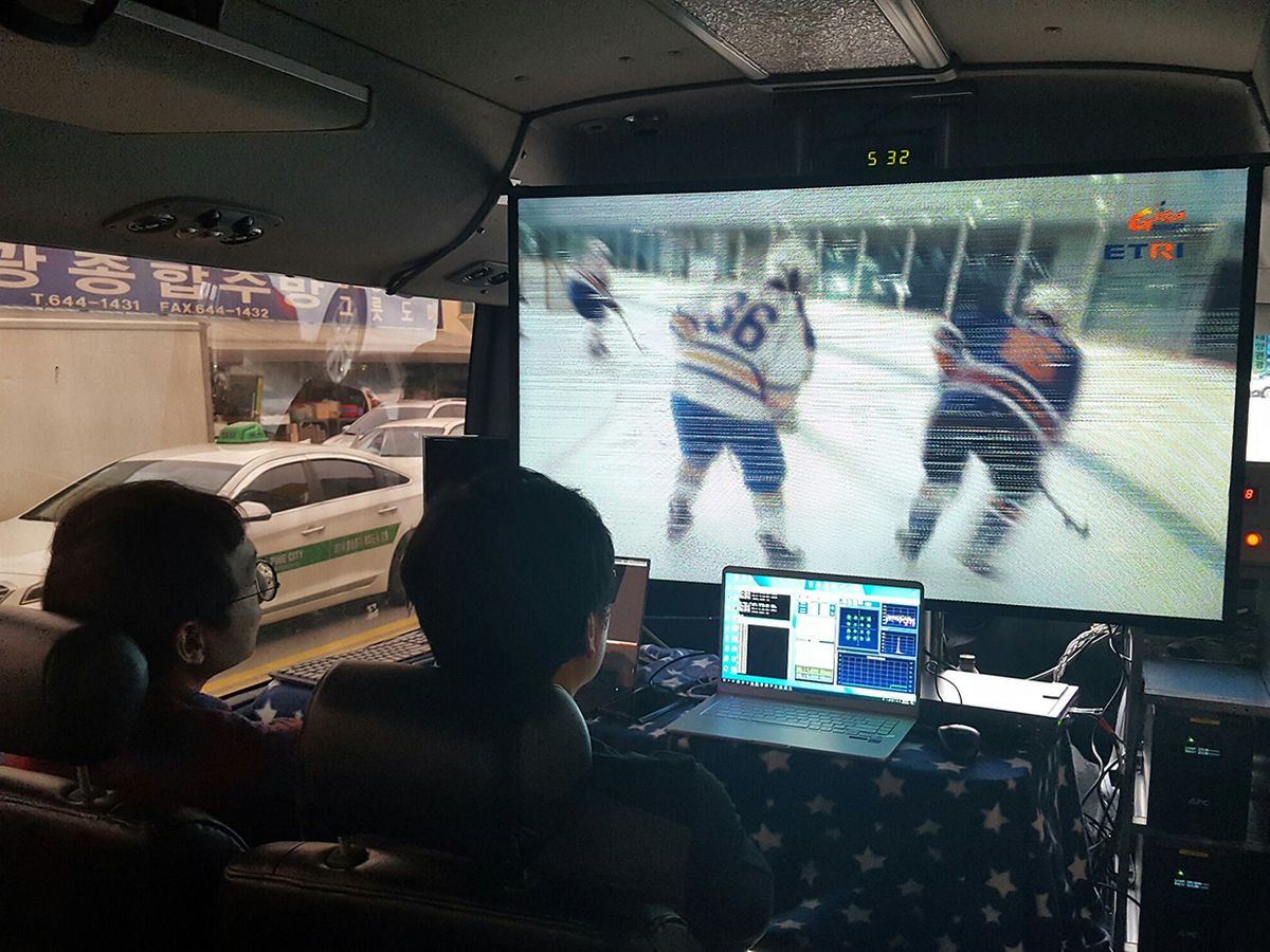 Users aboard 5G Champion's demo bus watch an ice hockey game streaming at 5 Gbps from a nearby 5G basestation.