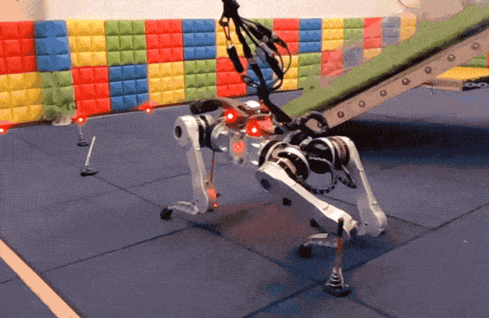 Video clips show a quadruped robot moving through an obstacle course and jumping over a colored pad.