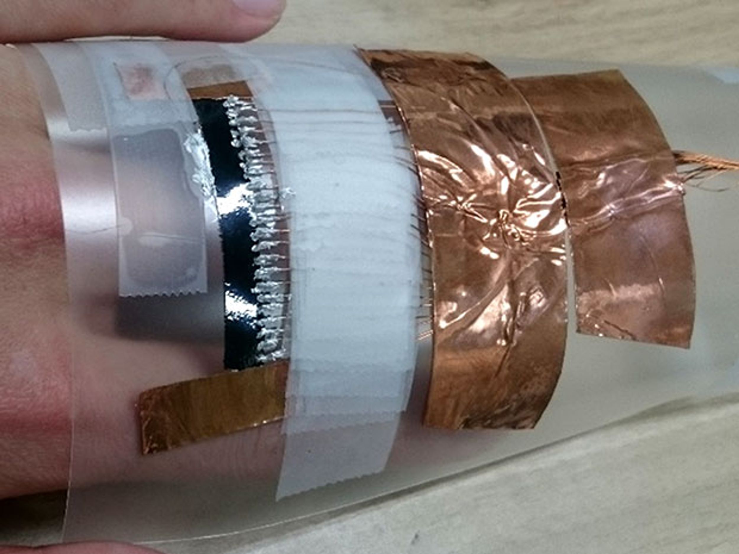 What looks like foil and wires wrapped around the back of a hand is a terahertz scanner made from carbon nanotubes
