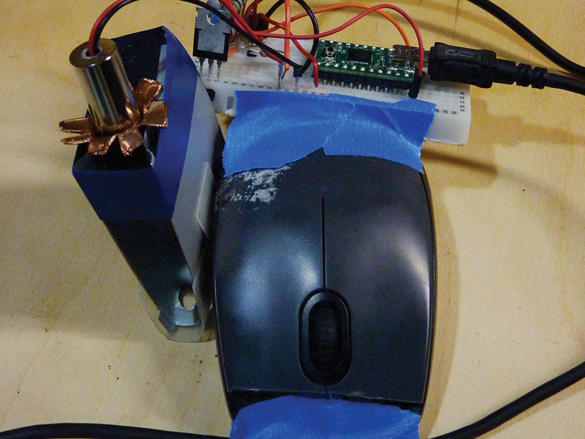 WORK IN PROGRESS: The prototype mouse engraver uses a microcontroller and a laser lashed to a US $10 mouse [top] connected to a PC. 
