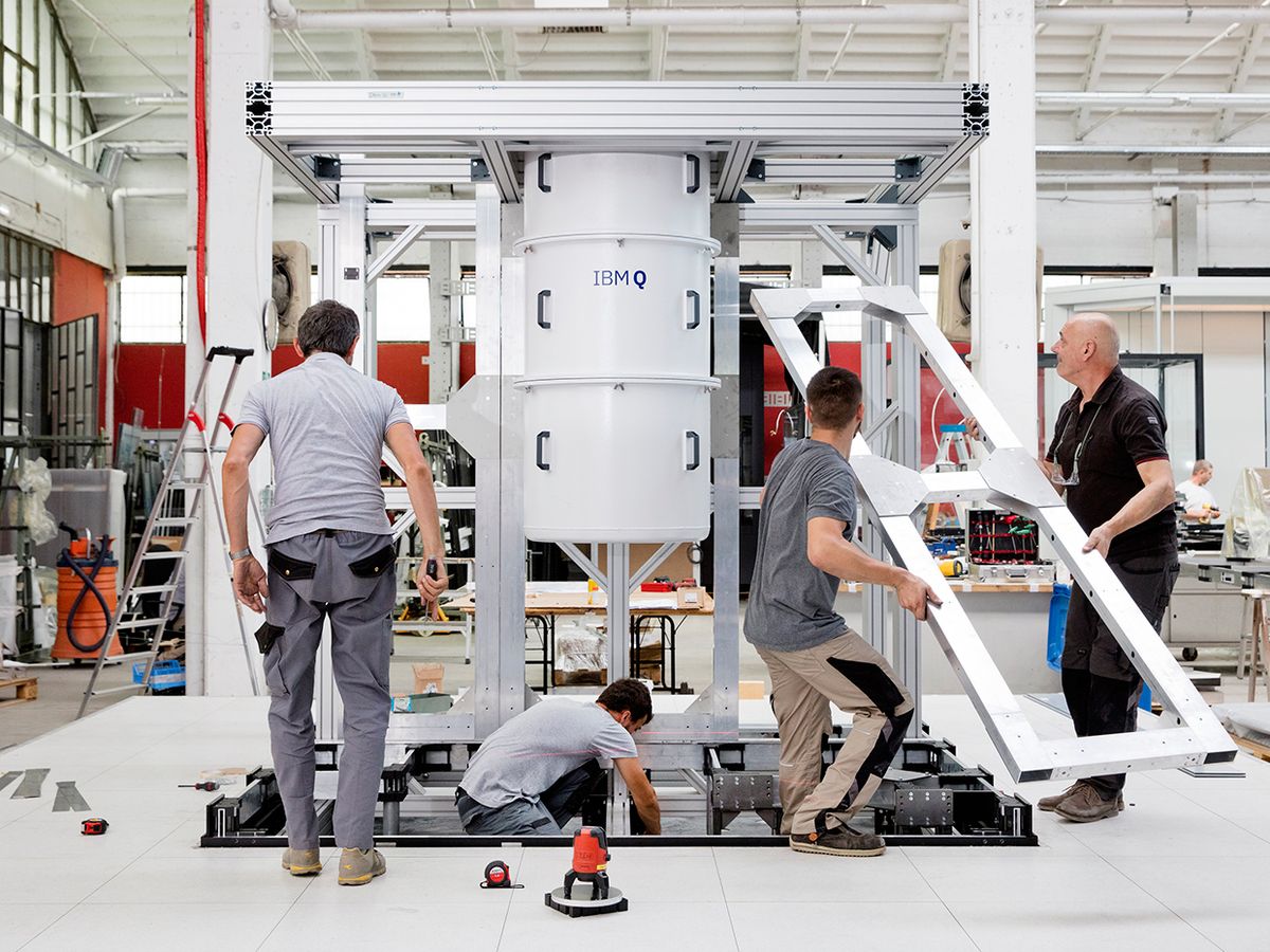 Workers assemble the enclosure for the IBM Q System One quantum computer.