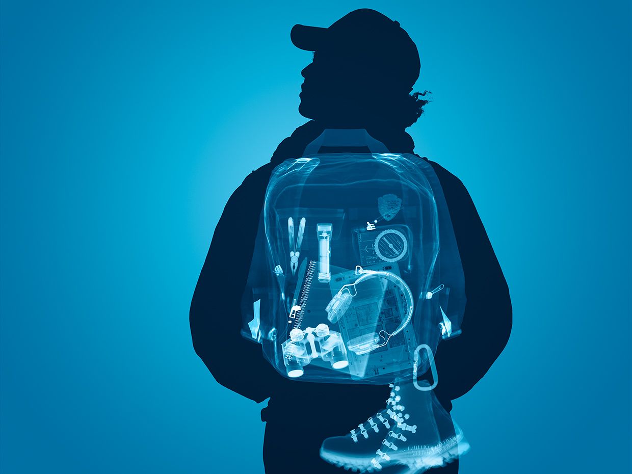 Young man's backpack is scanned, showing inside contents of electronics and tools.